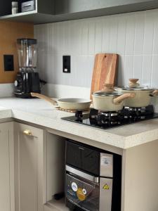 two pots and pans sitting on top of a stove in a kitchen at Villa D Castro in Gonçalves