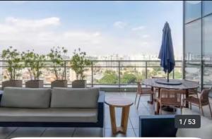 a living room with a couch and a table at The Cittyplex Osasco - new flat in Osasco