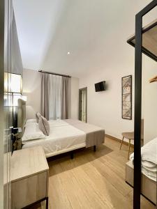 a hotel room with two beds and a table at Mape Loft Rural ALJIBE in Algar