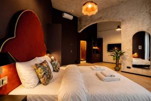 a bedroom with a large bed in a room at Maroon & Moss Residence in Budapest