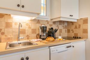 a kitchen with a sink and a counter top at Résidence Pierre & Vacances La Pinède in Hyères