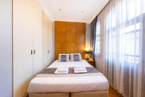 a bedroom with two beds and a large window at King Suite Hotel Beşiktaş in Istanbul