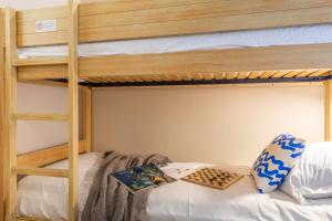 a bunk bed with a book on the bottom bunk at Résidence Pierre & Vacances La Pinède in Hyères