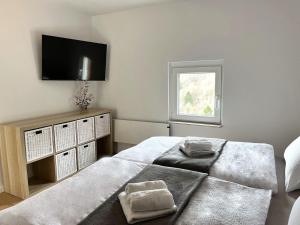 a bedroom with a bed and a television on the wall at Apple & Pear in Ročinj