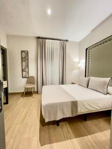 a bedroom with a large bed and a desk at Mape Loft Rural ALJIBE in Algar