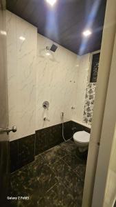 a bathroom with a toilet and a sink at the prestige ganga in Solapur