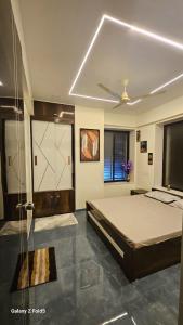 a bedroom with a bed and a glass shower at the prestige ganga in Solapur