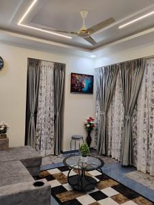 a living room with a couch and a table at the prestige ganga in Solapur