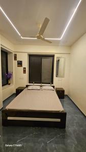 a bedroom with a bed and a ceiling fan at the prestige ganga in Solapur
