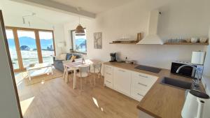 a kitchen with a table and a kitchen with a dining room at Domki na Wymyślu in Grywałd +5 photos