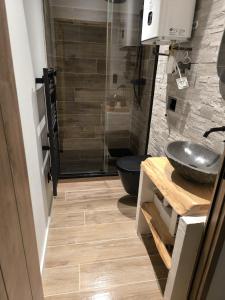 a bathroom with a sink and a glass shower at Escale à Clisson - Les jardins de Bali in Clisson +10 photos