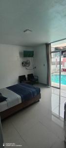 a bedroom with a bed and a swimming pool at the silva house in Huacachina +6 photos