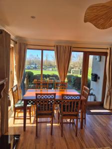 a dining room with a table and chairs and a large window at Harbour View Lodge in Dromod