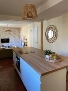 a kitchen with a counter with a bowl of fruit on it at -La Casa d'Avignon- in Avignon +21 photos