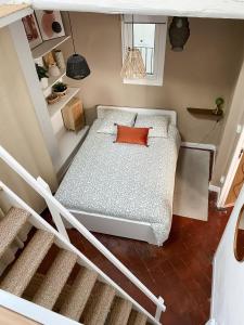 a bedroom with a bed with a red pillow at -La Casa d'Avignon- in Avignon