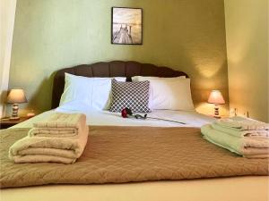 a bedroom with a bed with towels on it at Panorama Beach in Chrani