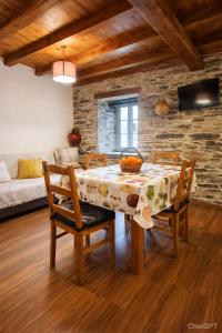 a dining room with a table and chairs and a couch at Casa do Salgueirinho in Casal do Rei