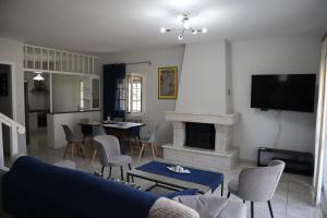 a living room with a couch and a fireplace at Galini Home 2 in Prokópion
