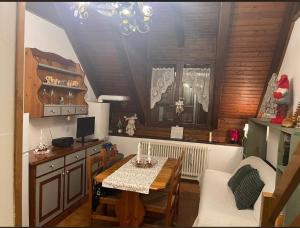 a kitchen with a table and a dining room with a table and chairs at Erika in Tarvisio +17 photos