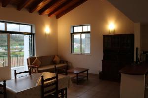a living room with a couch and a table at Montes da Barca in Aldeia Nova do Concelho