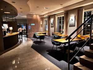 a restaurant with tables and chairs and a bar at Hotel Nowy Dwór in Trzebnica
