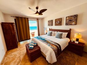 a bedroom with a bed with a view of the ocean at The Cerritos Beach Inn in El Pescadero +50 photos