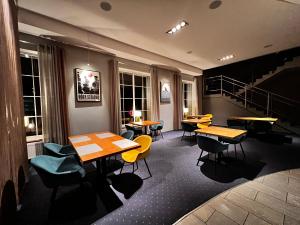 a restaurant with tables and chairs and a staircase at Hotel Nowy Dwór in Trzebnica +26 photos