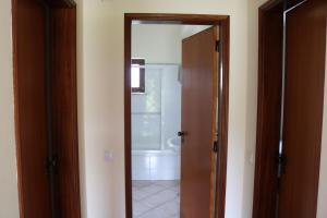 a bathroom with a door open to a bathroom with a tub at Montes da Barca in Aldeia Nova do Concelho +130 photos