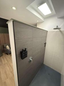 a bathroom with a shower with a metal door at Au bât Tournai chambre zen in Tournai