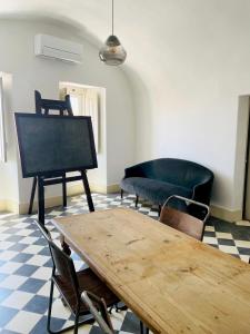 a living room with a table and a couch at Cosmogama House in Évora