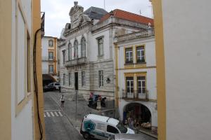 a view from a window of a street with buildings at Cosmogama House in Évora