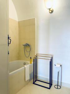 a bathroom with a bath tub and a sink at Cosmogama House in Évora +20 photos