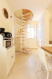 a kitchen with a spiral staircase in a room at Casa Germana, Marano Ticino in Marano Ticino +17 photos