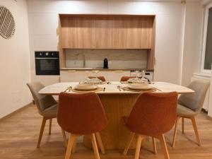 a kitchen with a table and chairs in a kitchen at La Mandarouseraie in Millau