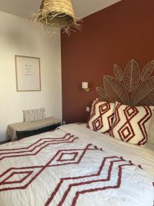 a bedroom with a large bed with a comforter at La Mandarouseraie in Millau +18 photos