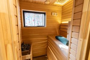 a sauna with a window in a wooden cabin at Chill out Spa Studio in Kotor