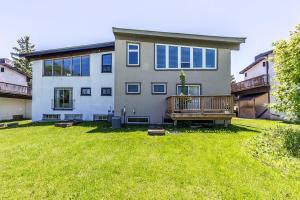 a large house with a large yard in front of it at Northview-Blue Mountain-Sauna-Firepit-Balcony-Parking in Blue Mountains