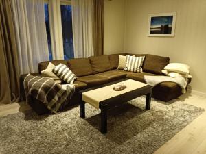 a living room with a couch and a coffee table at Artic home komfort in Tromsø +27 photos