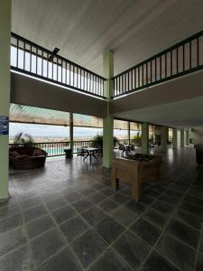 a large room with a table in a building at Flat Vila Monte Castelo in Gravatá
