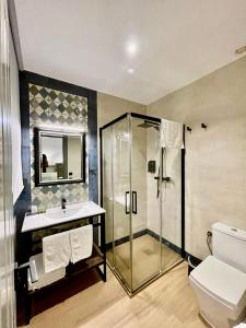 a bathroom with a shower and a sink and a toilet at Mape Loft Rural ALJIBE in Algar