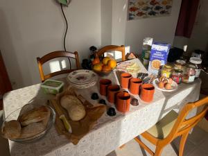 a table with bread and other food on it at Quinta Madrugada Burgau in Luz +41 photos