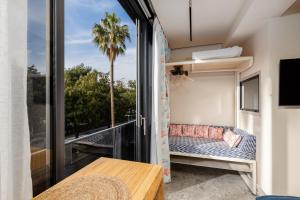 a room with a balcony with a couch and a window at Chill out Spa Studio in Kotor