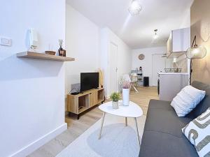 a living room with a couch and a table at Le Duc 1 - Appartement 2 pers - Centre Ville in Valence