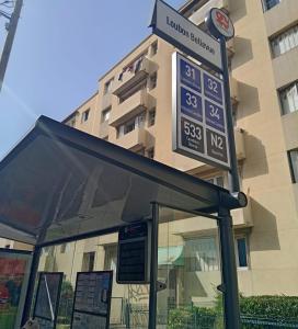 a sign at a bus stop in front of a building at chambre Marseille pas lon de saint Charles et vieux port in Marseille