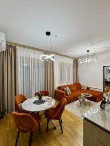 a living room with a table and a couch at Monte Relax - Wellness Oase in Zlatibor