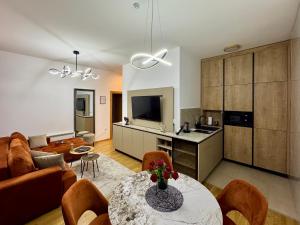 a kitchen and living room with a table and chairs at Monte Relax - Wellness Oase in Zlatibor