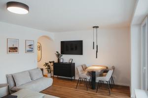 a living room with a couch and a table at Schwarzwald Loft Bergblick in St. Blasien