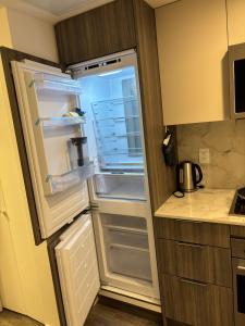 an empty refrigerator with its door open in a kitchen at Executive 2 beds and 1 bath suit in Surrey