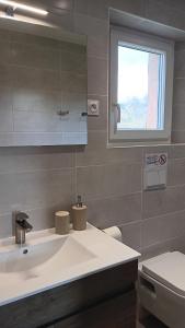 a bathroom with a sink and a toilet at Le Moulin du Comte in Bourrouillan +39 photos