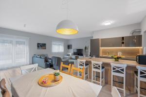 a kitchen and living room with a table and chairs at House Degenia in Lovinac +8 photos